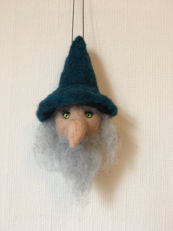 A hanging Bauble of a wizard head perfectly imperfect