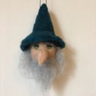 A hanging Bauble of a wizard head perfectly imperfect