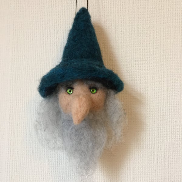 A hanging Bauble of a wizard head perfectly imperfect