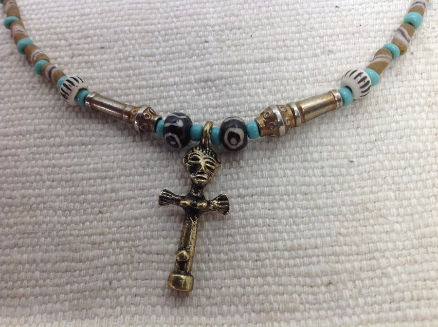 Necklace with an African brass charm and prayer beads from Tibet 
