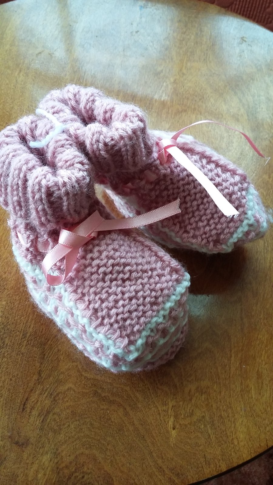 Pink bootees, hand knitted