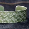Khaki aluminium cuff with seed head pattern