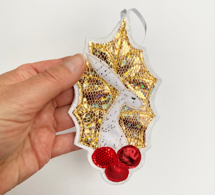 Upcycled embroidered golden holly leaf and berries hare home decoration. 