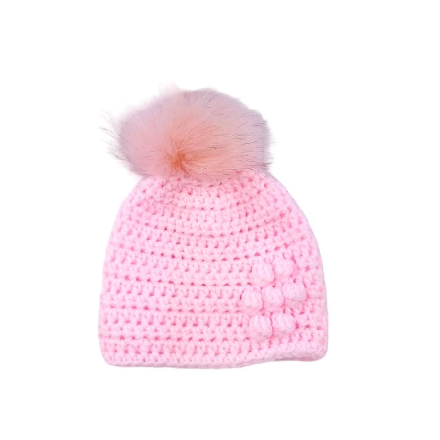 Pink baby crocheted hat with detachable pink faux fur pompom with brown tips