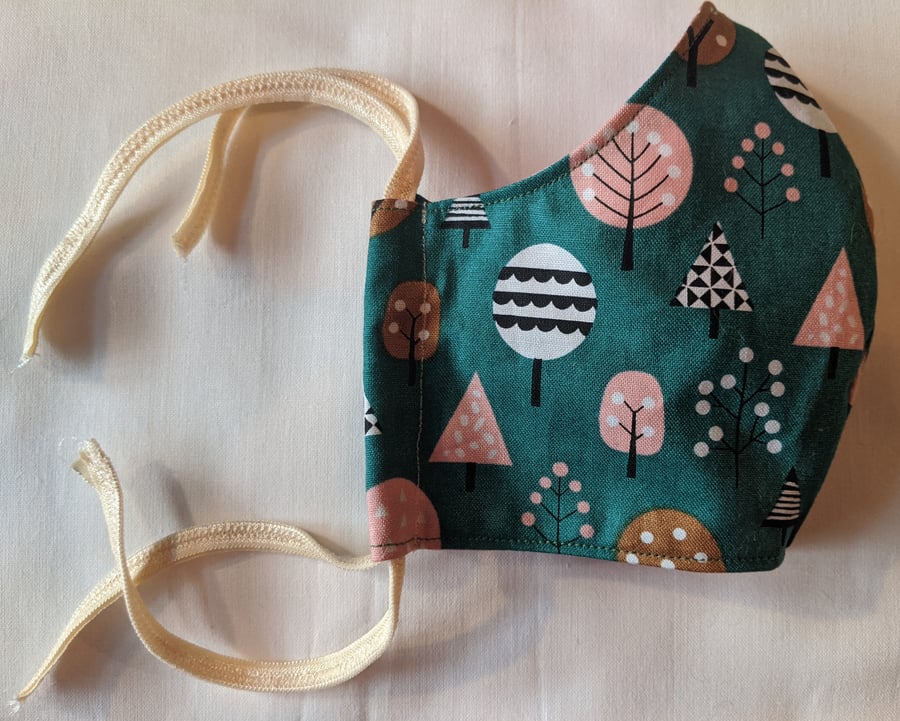 Cotton face mask with autumnal pastel tree pattern