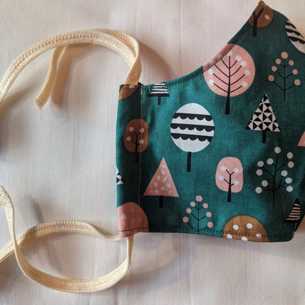Cotton face mask with autumnal pastel tree pattern
