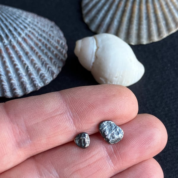 Mismatch pair of recycled oxidised silver stud earrings.