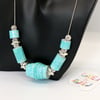 Winter blue and icicles themed necklace on a silver plated chain