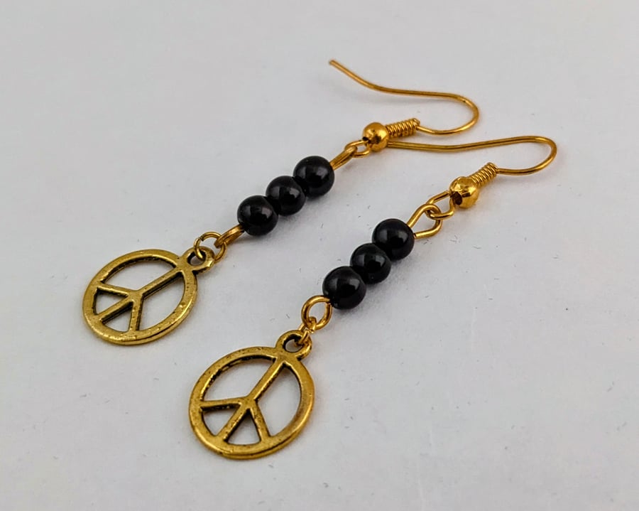 Black and gold peace sign earrings