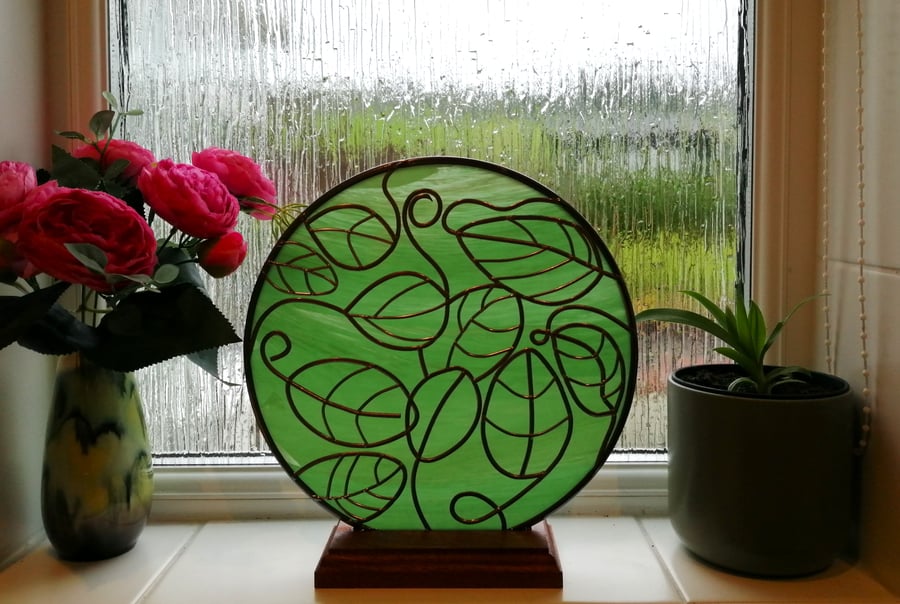 Harmonious is a 25cm round free-standing stained glass effect window panel 