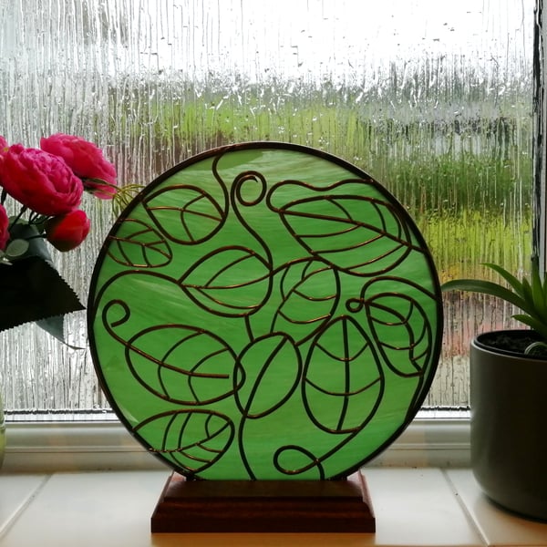 Harmonious is a 25cm round free-standing stained glass effect window panel 