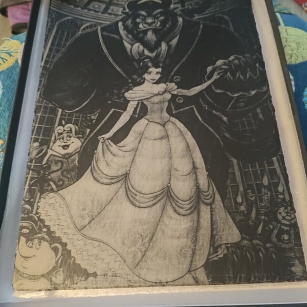 Beauty and the Beast" laser-engraved natural rock slate art piece.