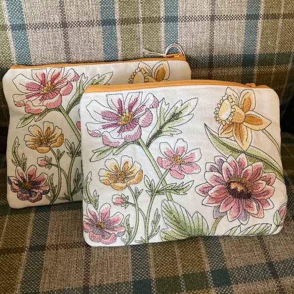 Embroidered Lined makeup bag. Double sided design. Zipped closure. 