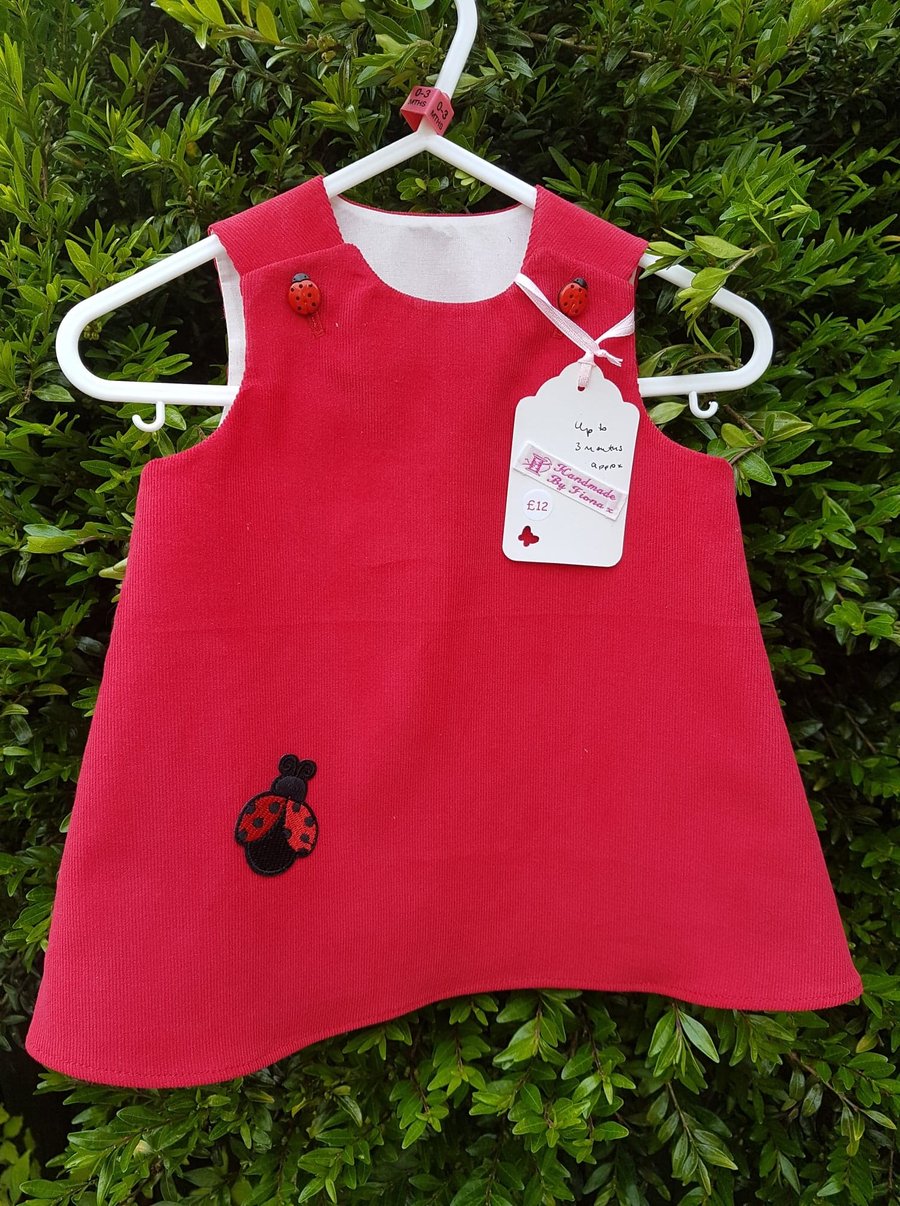 Age 0-3m: Red baby needlecord pinafore dress