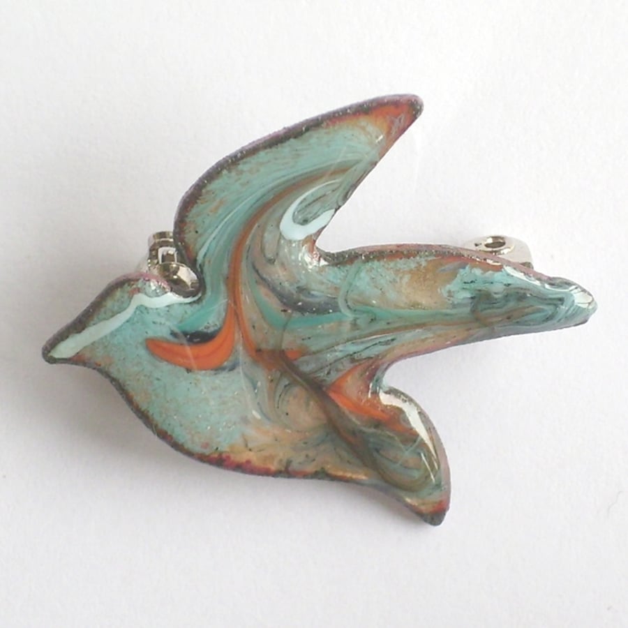 bird brooch - scrolled white, blue and orange over turquoise on clear enamel