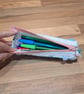 Pencil case - light pink and light green with pink zip, blue charm, and bobbles - Image 4