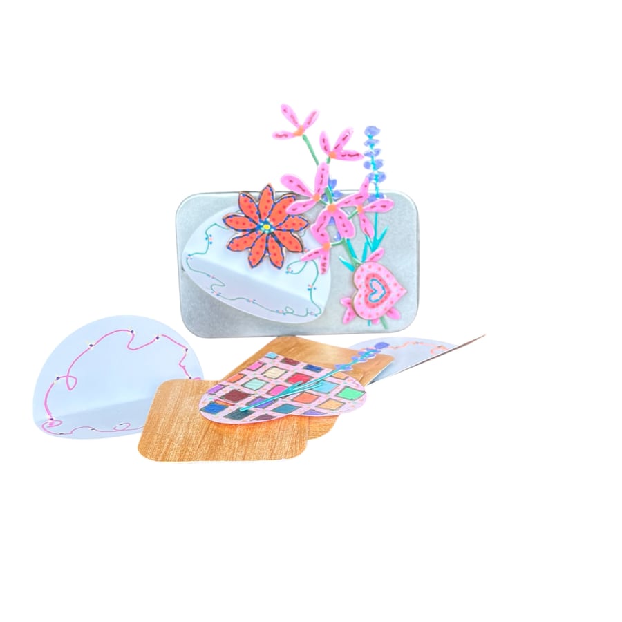 Selection of hand painted magnets and ephemera in a mini tin 