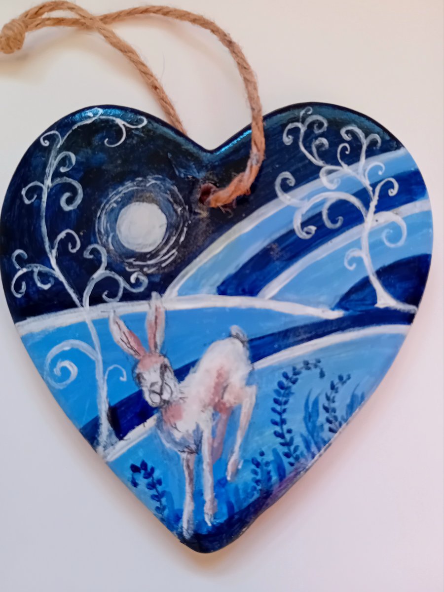Hare running  in moonlight with twist trees on a ceramic heart