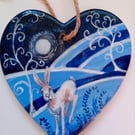 Hare running  in moonlight with twist trees on a ceramic heart