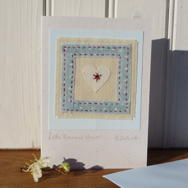 Hand-stitched miniature embroidery worked on heart mounted on greeting card