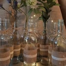 12 hand decorated up cycled bottles ina rustic vintage style 