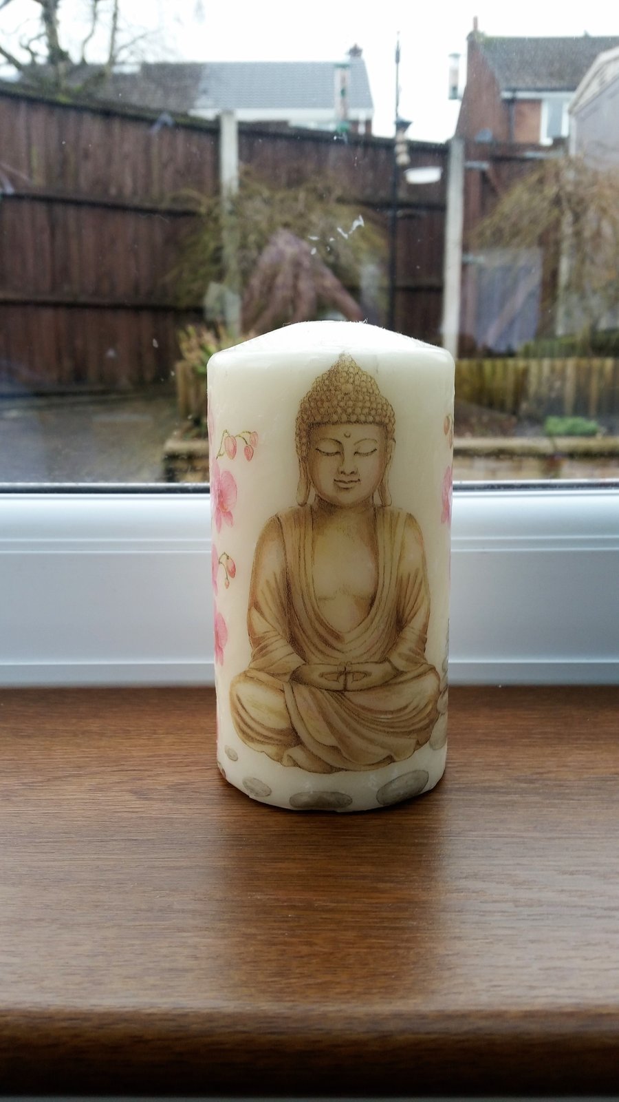 buddha candle with pink flowers