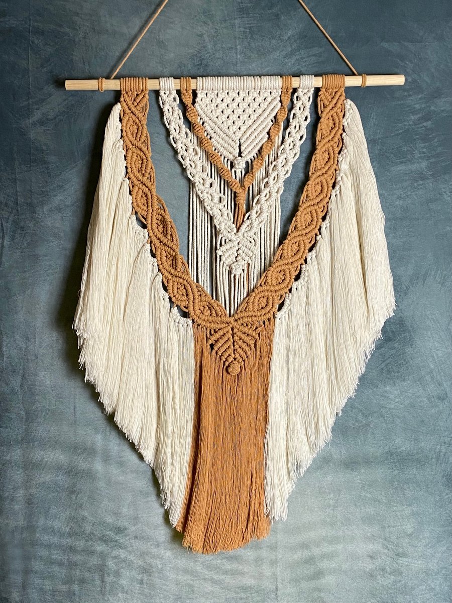 Macrame wall hanging with intricate knot design, light caramel and beige colours