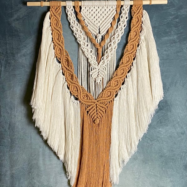 Macrame wall hanging with intricate knot design, light caramel and beige colours