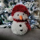 Snowman with red and white hat and scarf hand knitted and perfect for Christmas