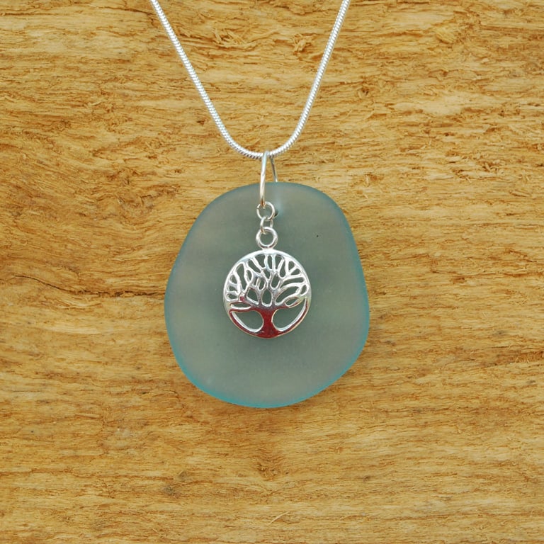 Blue beach glass pendant with tree of life charm