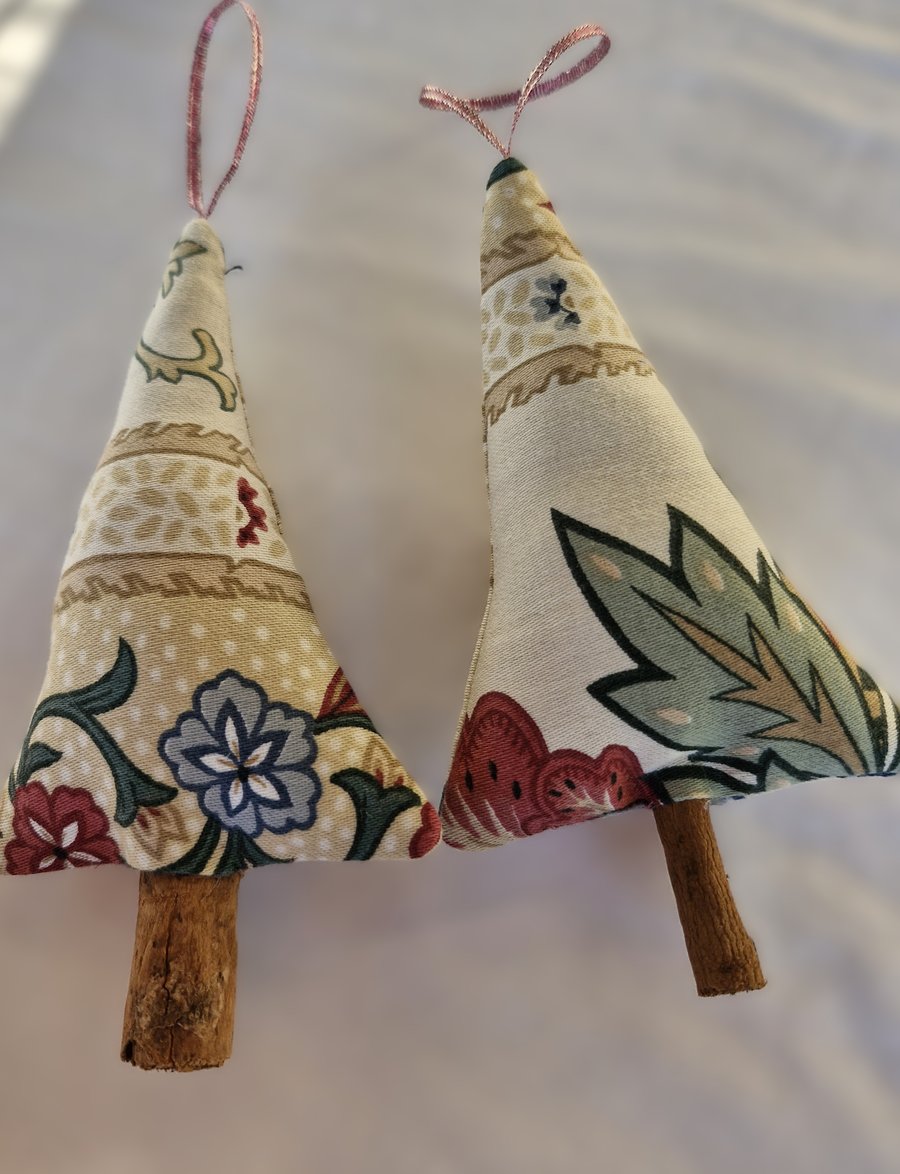 Pair of hand crafted fabric christmas tree decorations with cinnamon trunk