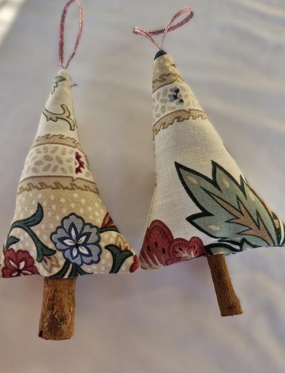 Pair of hand crafted fabric christmas tree decorations with cinnamon trunk