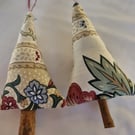 Pair of hand crafted fabric christmas tree decorations with cinnamon trunk