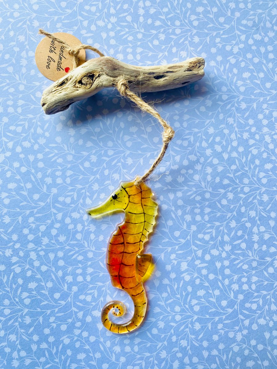 Orange  fused glass seahorse hanging sun catcher from driftwood 