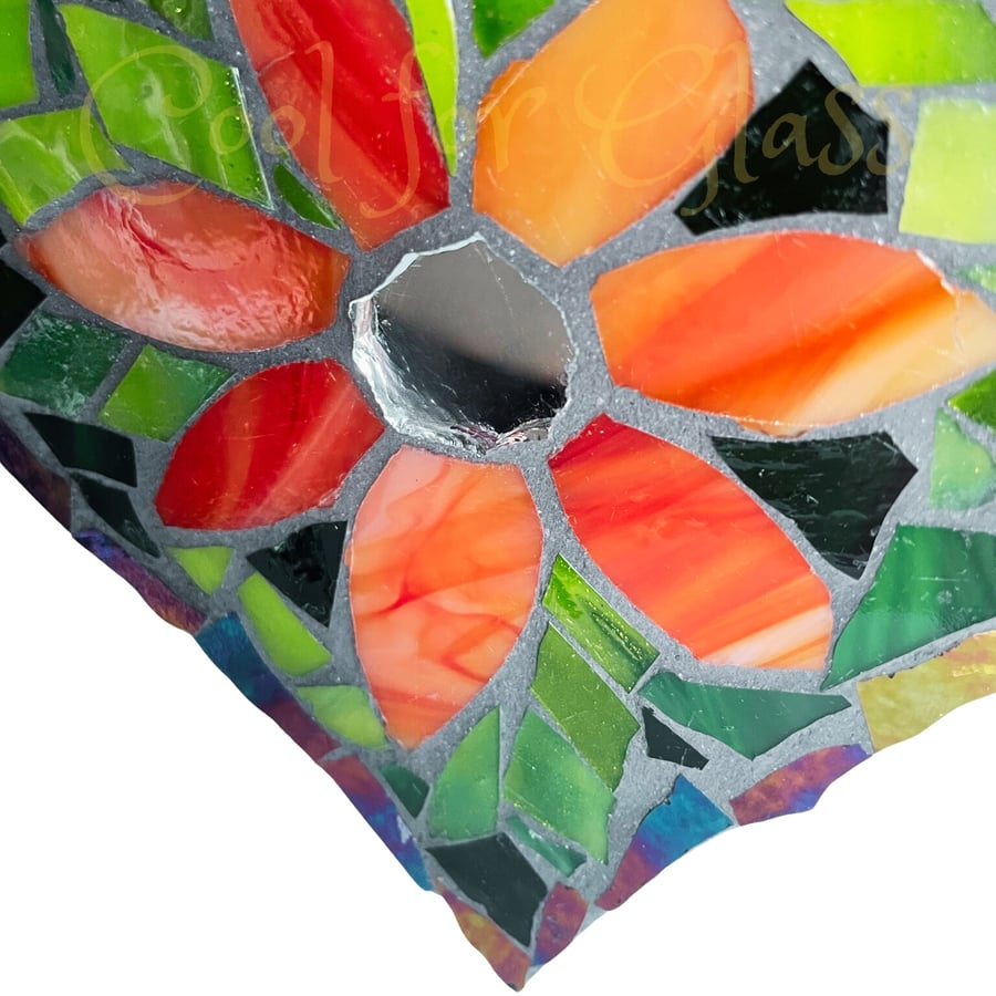 Stained glass mosaic heart with orange flowers