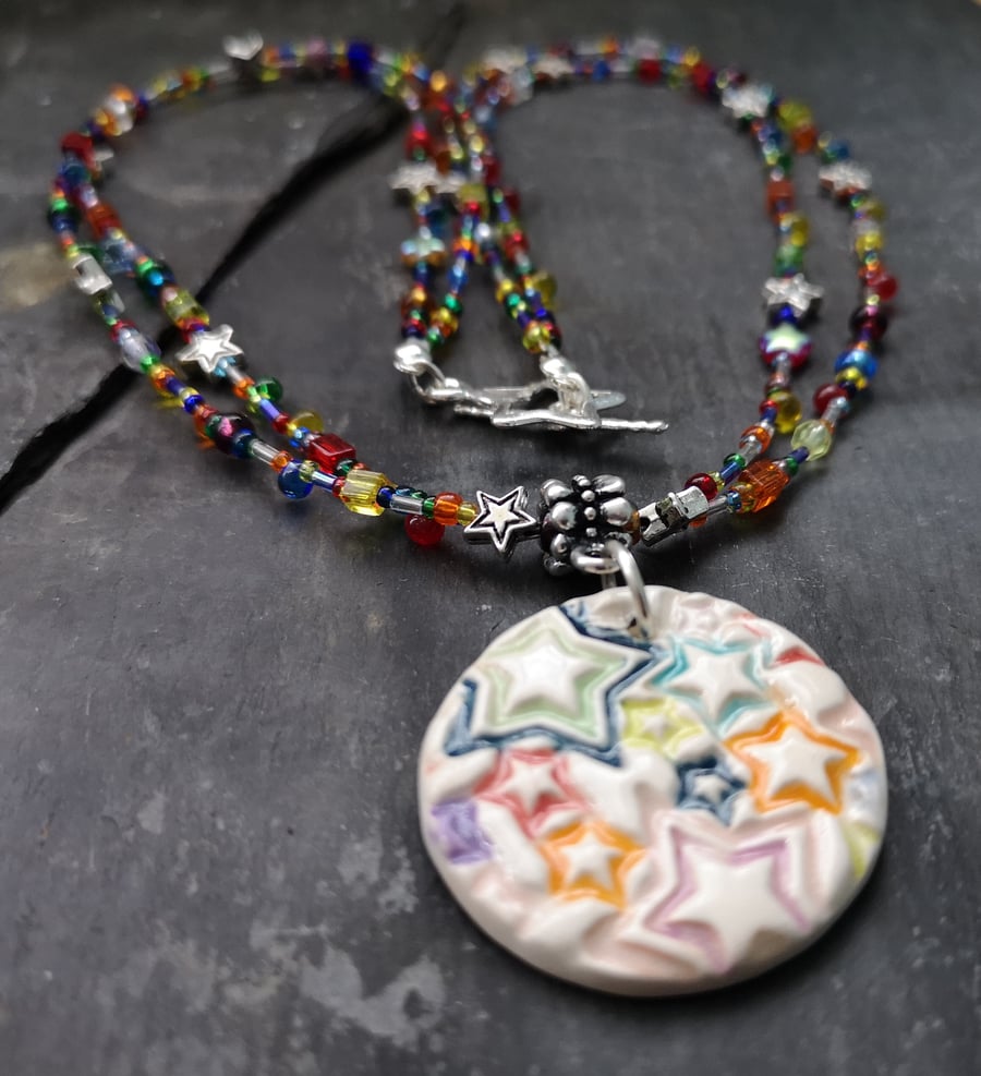 SALE round ceramic pendant with star pattern, glass beads and star clasp