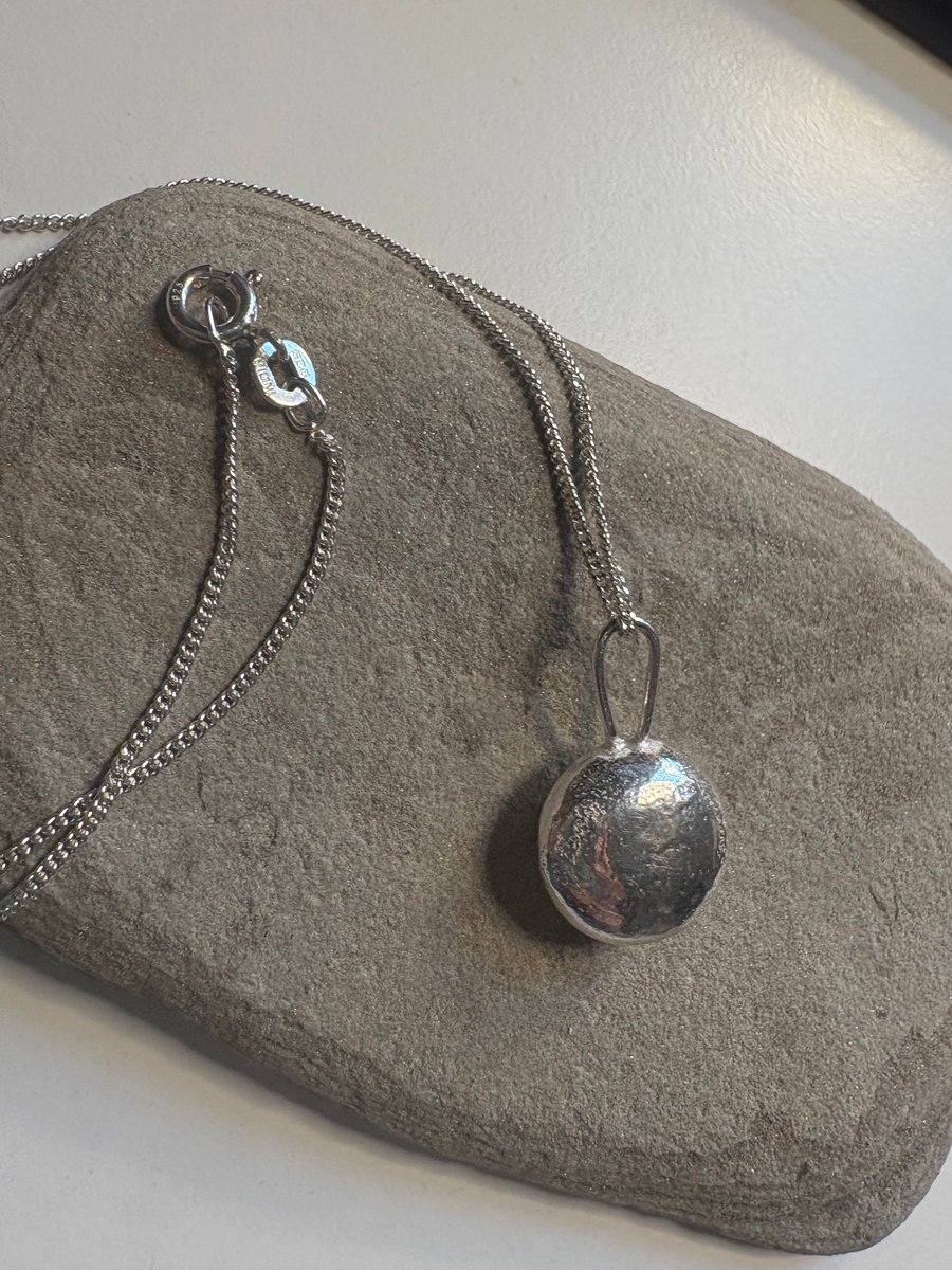 Sterling silver minstrel textured pendant on a silver chain
