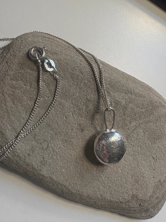 Sterling silver minstrel textured pendant on a silver chain