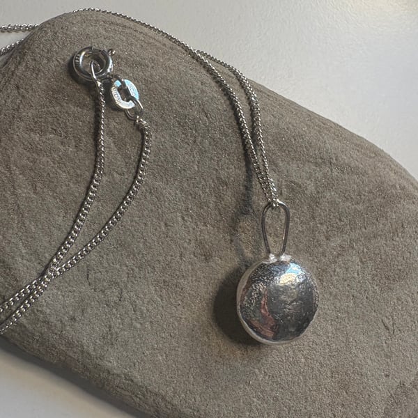 Sterling silver minstrel textured pendant on a silver chain