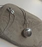 Sterling silver minstrel textured pendant on a silver chain