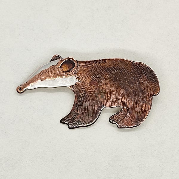 Badger brooch, copper