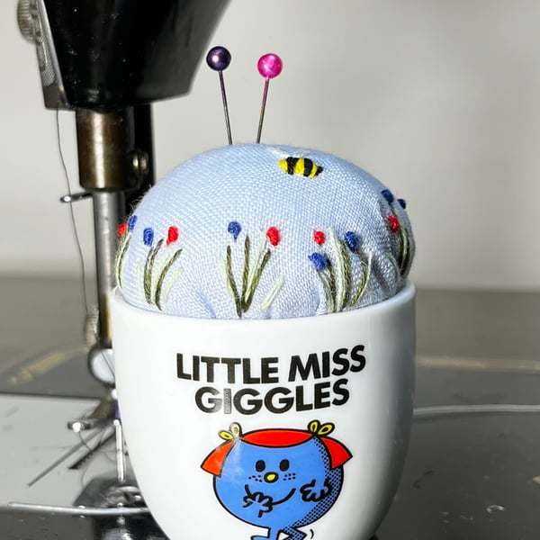 Little Miss Giggles egg cup embroidered pin cushion with bee and flowers