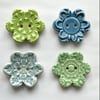 Set of four flower shaped ceramic handmade buttons