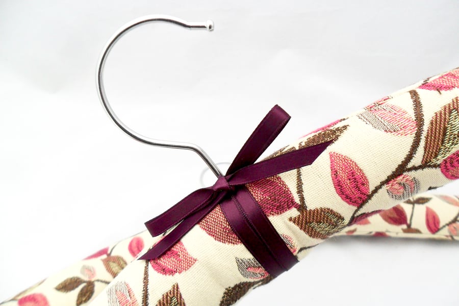 Padded coat hangers in a floral Jacquard fabric