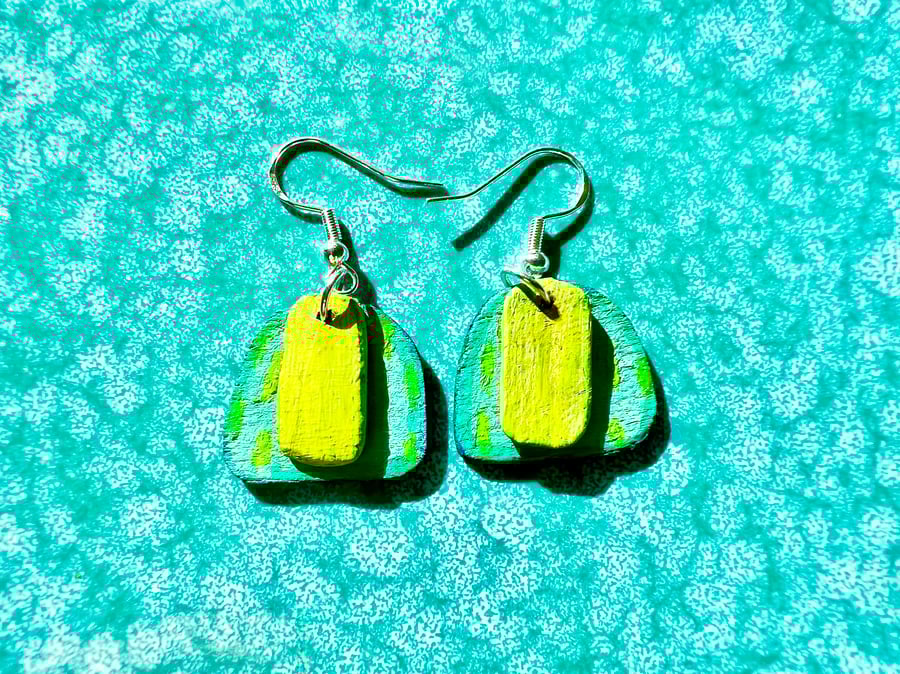 Wooden dangly earrings painted in vibrant greens and teal on silver plated hooks