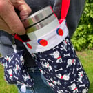 Water bottle carrier with pocket for phone. Navy and red with dog pattern
