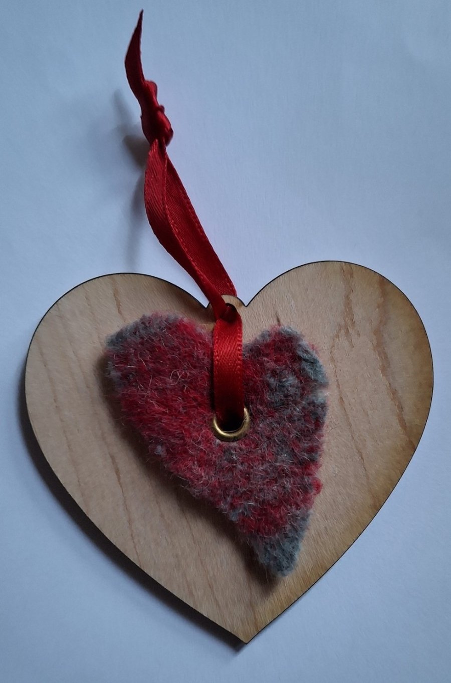 Needle-felted heart on wooden decoration