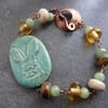 green ceramic hare, lampwork and copper bracelet