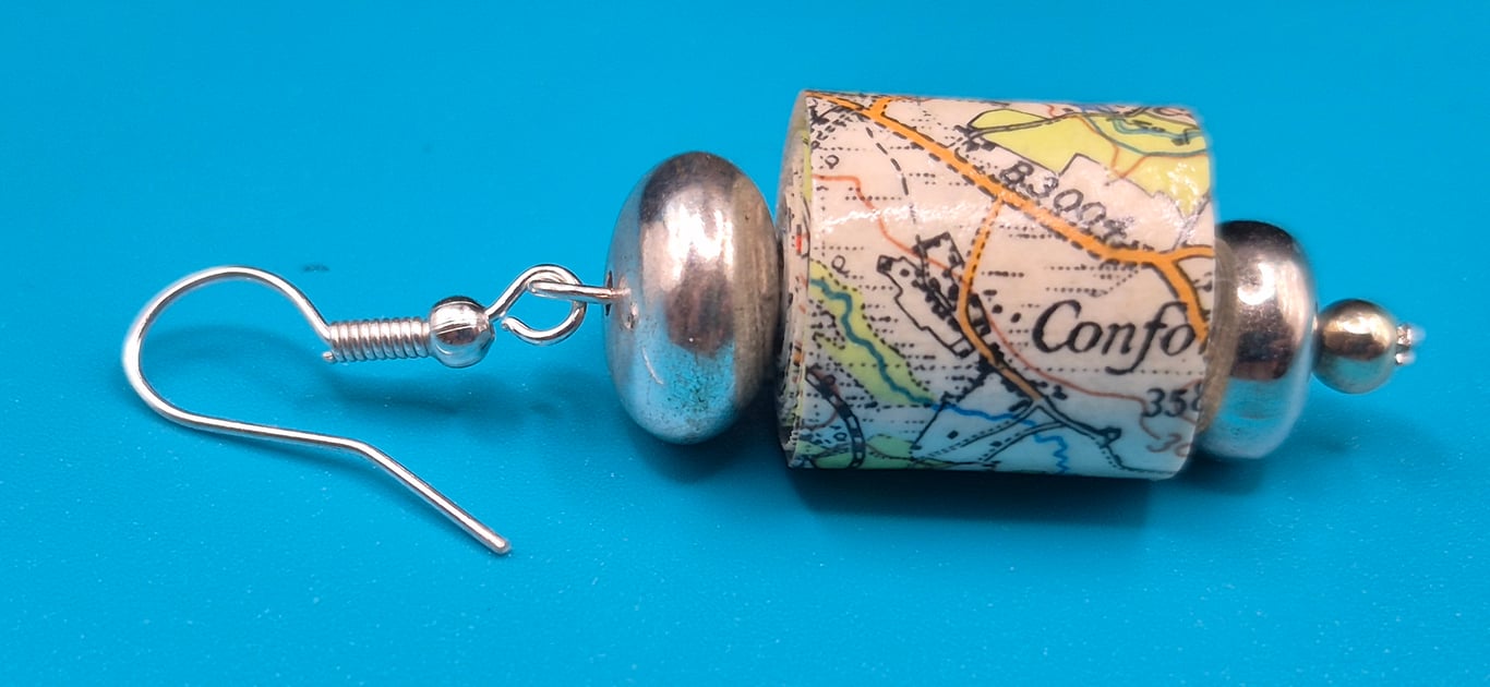 Barrel paper beaded earrings made with old OS map of Chichester and silvery bead