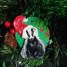 Christmas tree decoration of a Badger with a santa hat made from air dry clay.  